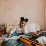 child packing a suitcase for summer camp