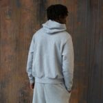 grey essentials hoodie on person